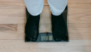 close up of person's feet standing on a scale