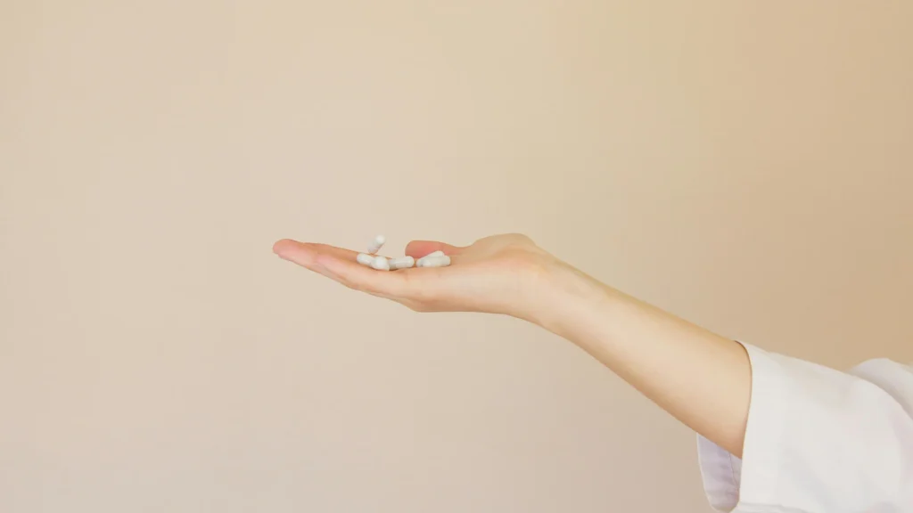 close up of hand holding various pills