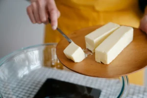 close up of person cooking with butter