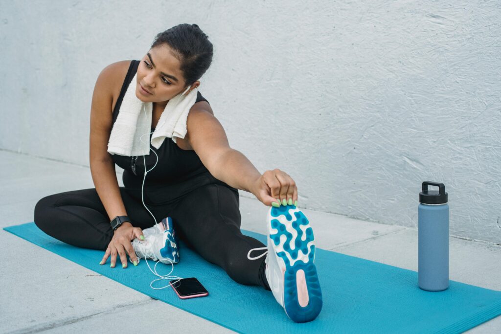 woman stretching on yoga mat